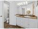 Bright bathroom featuring a double sink vanity with granite countertops and a separate toilet room at 6009 Cedarwood Ln, Bradenton, FL 34203