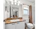 Bathroom featuring a granite vanity and a shower-tub combo with a shower curtain at 6009 Cedarwood Ln, Bradenton, FL 34203