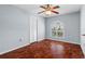 Sunlit bedroom with light blue walls, wood-look floors, and a large arched window at 6009 Cedarwood Ln, Bradenton, FL 34203