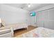 Bedroom with two beds, wood-look floors, and a flat-screen television at 6009 Cedarwood Ln, Bradenton, FL 34203