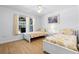 Bright bedroom with two twin beds, a ceiling fan, and views to the backyard pool at 6009 Cedarwood Ln, Bradenton, FL 34203
