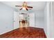 Bedroom with wood-look floors and an open doorway into the living area at 6009 Cedarwood Ln, Bradenton, FL 34203