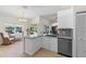 Well-lit kitchen with granite countertops and a view of the patio at 6009 Cedarwood Ln, Bradenton, FL 34203
