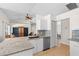 Bright kitchen with an island and a view of the living room at 6009 Cedarwood Ln, Bradenton, FL 34203