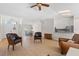Sunlit living room showcasing a seamless flow to the dining and kitchen areas at 6009 Cedarwood Ln, Bradenton, FL 34203