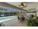 Covered patio with a pool, comfortable seating, and an outdoor fan at 6009 Cedarwood Ln, Bradenton, FL 34203