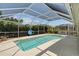 Screened pool area featuring a sparkling pool, ample seating, and serene outdoor living space at 6009 Cedarwood Ln, Bradenton, FL 34203