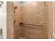Shower stall with beige tiled walls, grab bar, and hand-held shower head at 6009 Cedarwood Ln, Bradenton, FL 34203