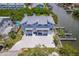 Waterfront home featuring multiple garages, a boat dock, and a large driveway at 601 2Nd St, Indian Rocks Beach, FL 33785