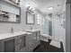 Modern bathroom featuring double sinks, decorative mirrors, and a glass enclosed shower at 601 2Nd St, Indian Rocks Beach, FL 33785