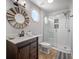 Bathroom with shower, white subway tile, and decorative mirror and vanity at 601 2Nd St, Indian Rocks Beach, FL 33785