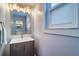 Bathroom vanity with updated mirror and lighting at 601 2Nd St, Indian Rocks Beach, FL 33785