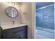 Beautiful bathroom with a dark vanity and a shower featuring glass doors and a tiled wall at 601 2Nd St, Indian Rocks Beach, FL 33785