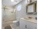 Bathroom with shower over tub and decorative mirror and vanity at 601 2Nd St, Indian Rocks Beach, FL 33785
