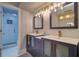 Modern bathroom featuring a double vanity with stylish fixtures and a glass-enclosed shower at 601 2Nd St, Indian Rocks Beach, FL 33785