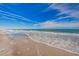 Beautiful view of ocean with white waves approaching sandy beach on sunny day at 601 2Nd St, Indian Rocks Beach, FL 33785
