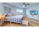 Well-lit bedroom with stylish furniture, a large window, and decorative artwork at 601 2Nd St, Indian Rocks Beach, FL 33785