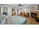 This spacious bedroom boasts wood floors, a barn door to the bathroom, and a fireplace at 601 2Nd St, Indian Rocks Beach, FL 33785