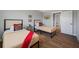 Bedroom with two twin beds, wood floors, ceiling fan, art, and window for lots of natural light at 601 2Nd St, Indian Rocks Beach, FL 33785