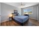 Bedroom with wood floors, ceiling fan, desk, and large window offering natural light at 601 2Nd St, Indian Rocks Beach, FL 33785