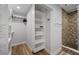 Walk-in closet with modern shelving, conveniently located next to the beautifully tiled glass shower at 601 2Nd St, Indian Rocks Beach, FL 33785