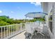 Outdoor deck area features white patio furniture and an umbrella with lush tropical views at 601 2Nd St, Indian Rocks Beach, FL 33785