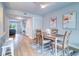 Dining area with seating for four, flamingo art, and access to the kitchen at 601 2Nd St, Indian Rocks Beach, FL 33785