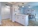 Dining area features white cabinets with stylish hardware and wood flooring at 601 2Nd St, Indian Rocks Beach, FL 33785