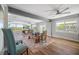 Open dining room with large windows, a wooden table, and stylish decor at 601 2Nd St, Indian Rocks Beach, FL 33785