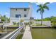 Waterfront home featuring a private dock, yard, and stairway to upper levels at 601 2Nd St, Indian Rocks Beach, FL 33785