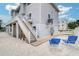 Exterior of the home featuring steps leading to a second level, and lounge chairs in the yard at 601 2Nd St, Indian Rocks Beach, FL 33785