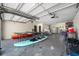 Spacious garage featuring a ping pong table, various watercraft, and ample storage space at 601 2Nd St, Indian Rocks Beach, FL 33785