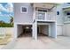 Exterior shot showing bottom floor garages, one with an open garage door, a second one closed at 601 2Nd St, Indian Rocks Beach, FL 33785