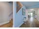 Hallway with staircase, wood floors, and a bench with decorative pillows and an inviting atmosphere at 601 2Nd St, Indian Rocks Beach, FL 33785