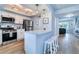 Bright kitchen with white cabinets, a breakfast bar, and stainless steel appliances at 601 2Nd St, Indian Rocks Beach, FL 33785