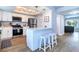 Modern kitchen with white cabinets, stainless steel appliances, and a breakfast bar with stools at 601 2Nd St, Indian Rocks Beach, FL 33785