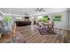 Bright living room with large windows, comfortable seating, and views of nature at 601 2Nd St, Indian Rocks Beach, FL 33785