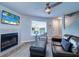 Bright living room featuring a fireplace, comfortable seating, and a view through a large window at 601 2Nd St, Indian Rocks Beach, FL 33785