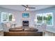 Cozy living room with fireplace and ceiling fan at 601 2Nd St, Indian Rocks Beach, FL 33785