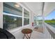 Covered porch with water views, small round wooden table and grilling area at 601 2Nd St, Indian Rocks Beach, FL 33785