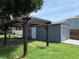 The backyard boasts a covered patio, green space and a detached garage at 6426 S Himes Ave, Tampa, FL 33611