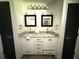 This bathroom offers double sinks, marble countertops, and two vanity mirrors at 6426 S Himes Ave, Tampa, FL 33611