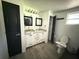 This bathroom includes double sinks, modern lighting, and tile flooring at 6426 S Himes Ave, Tampa, FL 33611