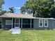 Cozy home with a screened-in porch, providing a relaxing space to enjoy the outdoors at 6426 S Himes Ave, Tampa, FL 33611