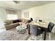 Inviting living area with a plush sofa, area rug, and access to a dining space at 6426 S Himes Ave, Tampa, FL 33611