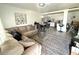 Open-concept living area with a comfortable sectional sofa and adjacent modern kitchen at 6426 S Himes Ave, Tampa, FL 33611