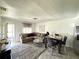 This living room includes modern flooring, a sectional couch, and a dining table at 6426 S Himes Ave, Tampa, FL 33611