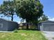 Spacious backyard featuring a detached garage and pergola, perfect for outdoor activities and relaxation at 6426 S Himes Ave, Tampa, FL 33611
