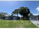 Charming home featuring a lush backyard, detached garage, and inviting pergola for outdoor gatherings at 6426 S Himes Ave, Tampa, FL 33611