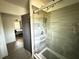 Modern shower with gray tiling and glass enclosure, leading to the Primary bedroom at 6426 S Himes Ave, Tampa, FL 33611